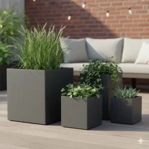 Set of three varying sizes of dark gray garden cubes placed together on a wooden deck.