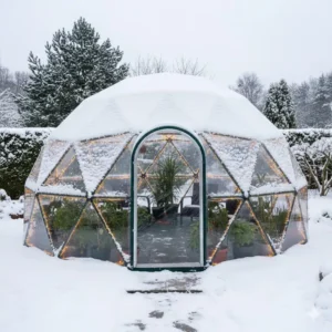 A durable winter greenhouse dome for outside covered in snow protecting garden plants.
